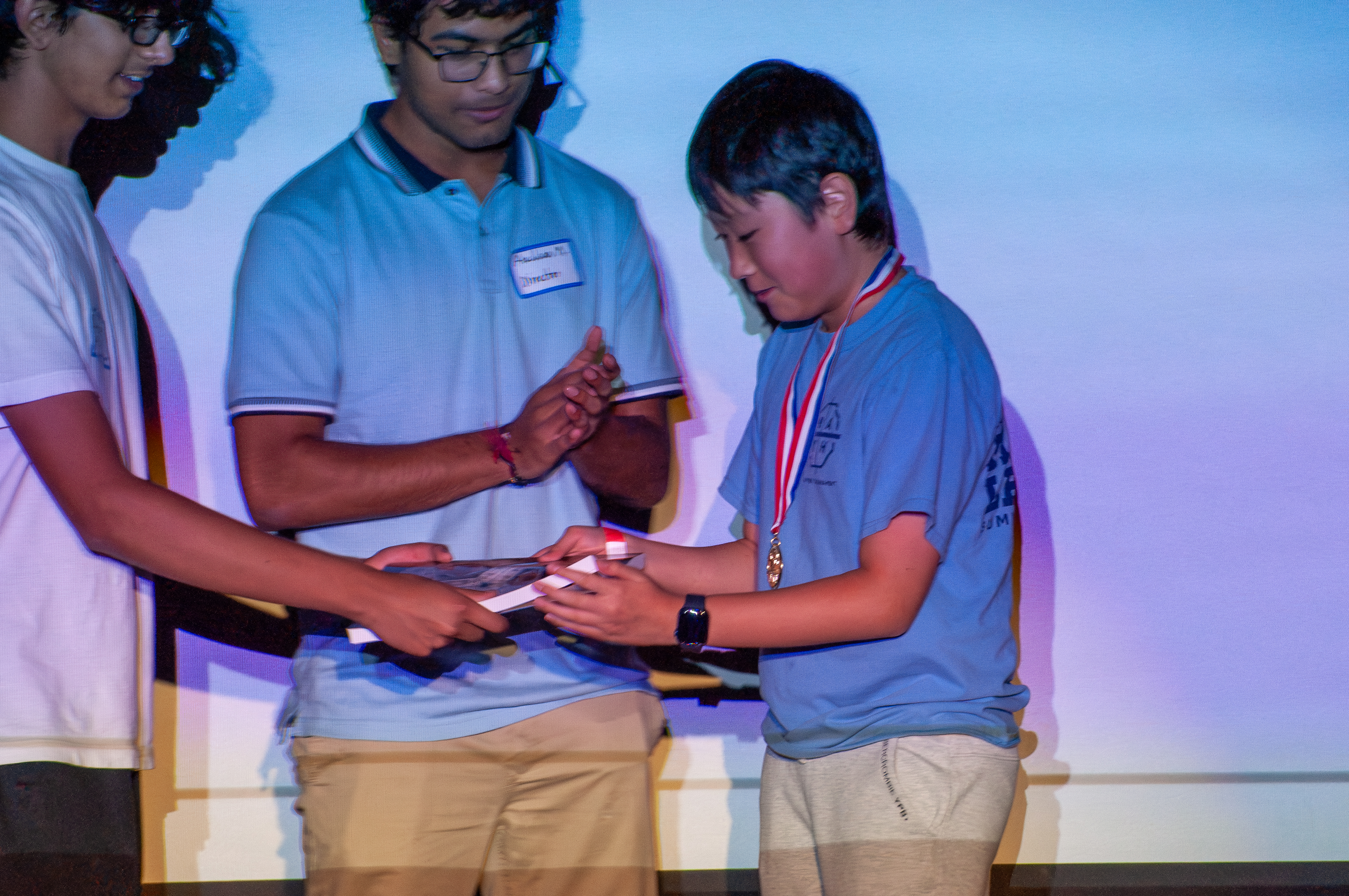 Volunteers waving from stage